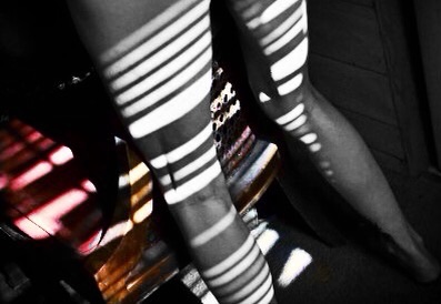 Just legs.  And I love the light from the door window shutters playing across them.  